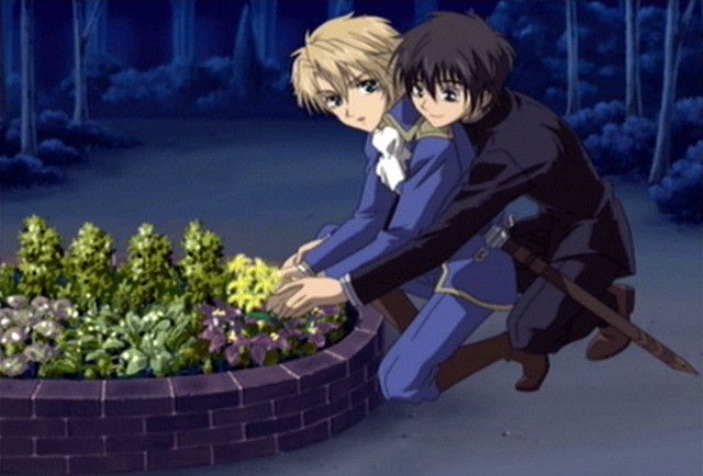 two anime characters are hugging in front of a planter