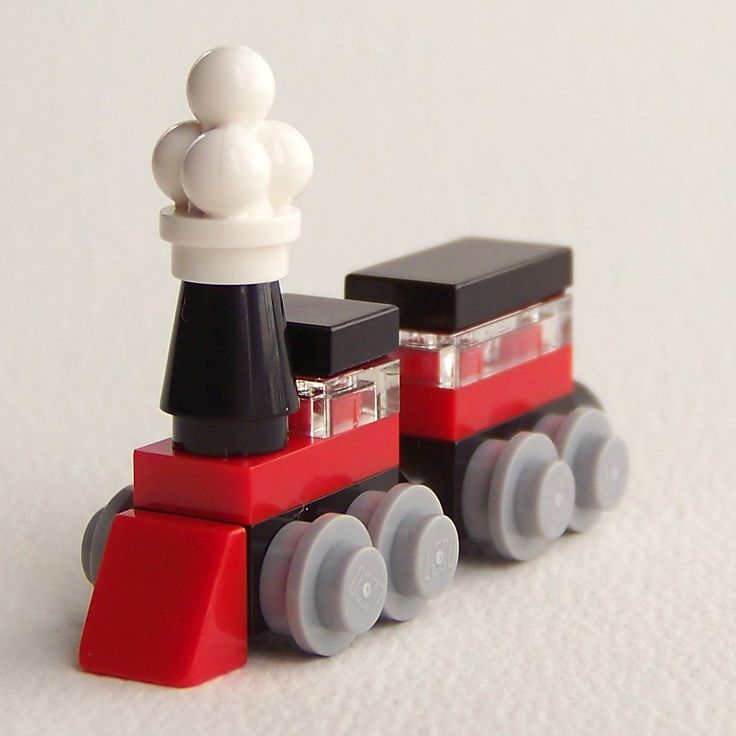 a toy train is shown on a white surface