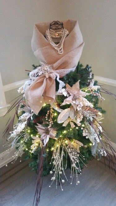 a christmas tree decorated with lights and bows