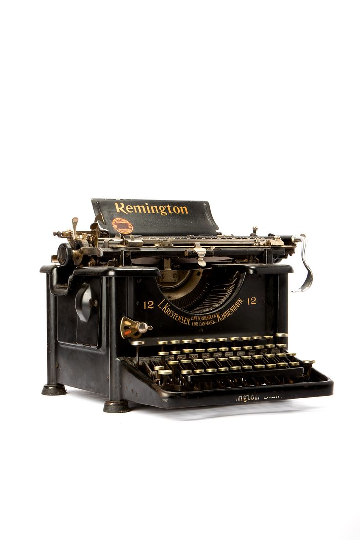 an old fashioned black typewriter sitting on top of a white surface with the words,