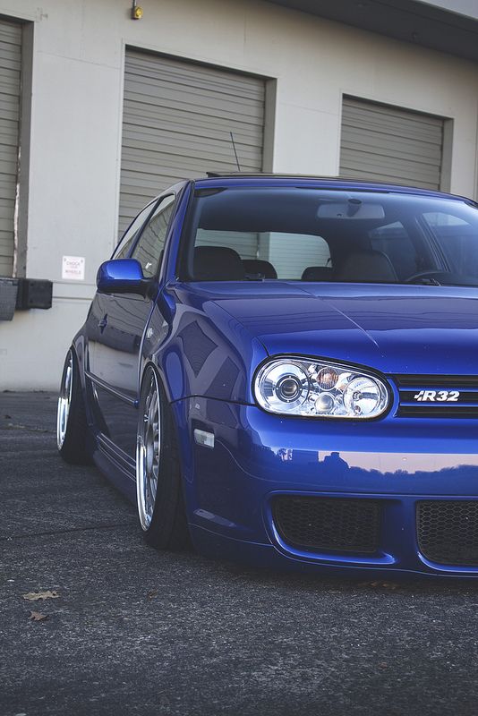 a blue car parked in front of a building