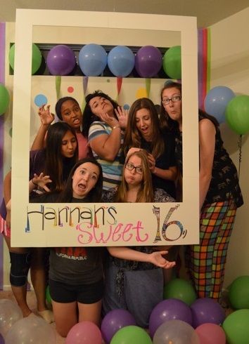 a group of people posing for a photo in front of balloons and a sign that says, farmers sweet 16