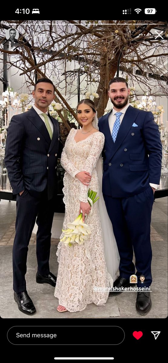 two men and a woman in formal wear posing for a photo on their wedding day