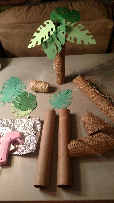 some crafting supplies are laid out on a table and ready to be made into palm trees