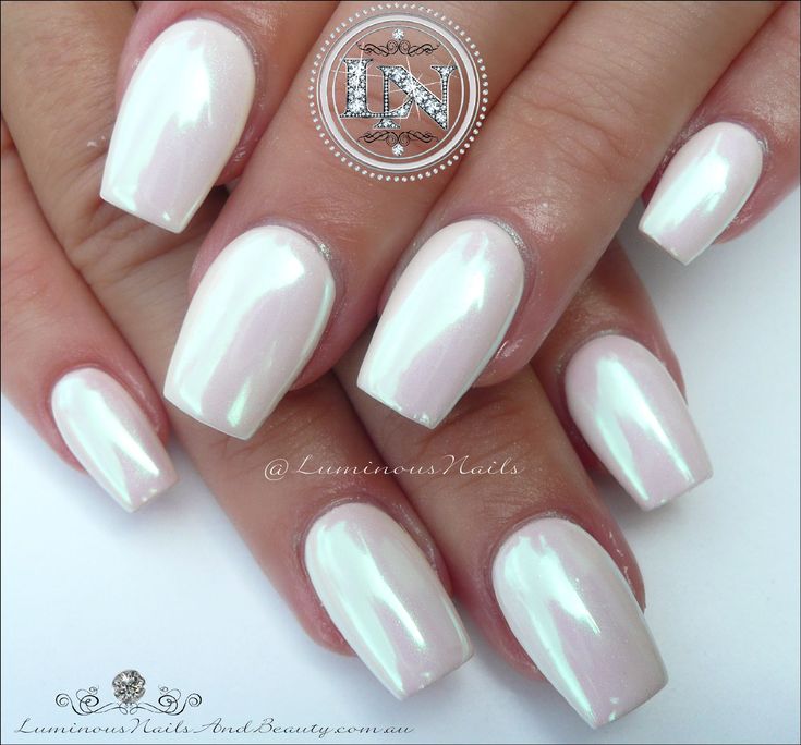 a woman's hand with white manies and nail polish on her nails,