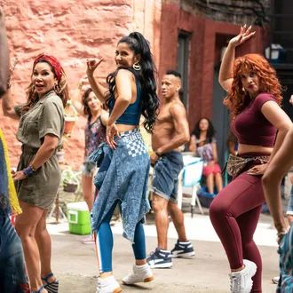 group of young women dancing in the street