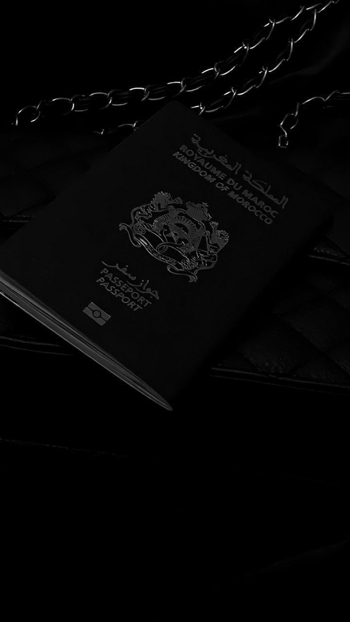 a black and white photo of a passport on a chain