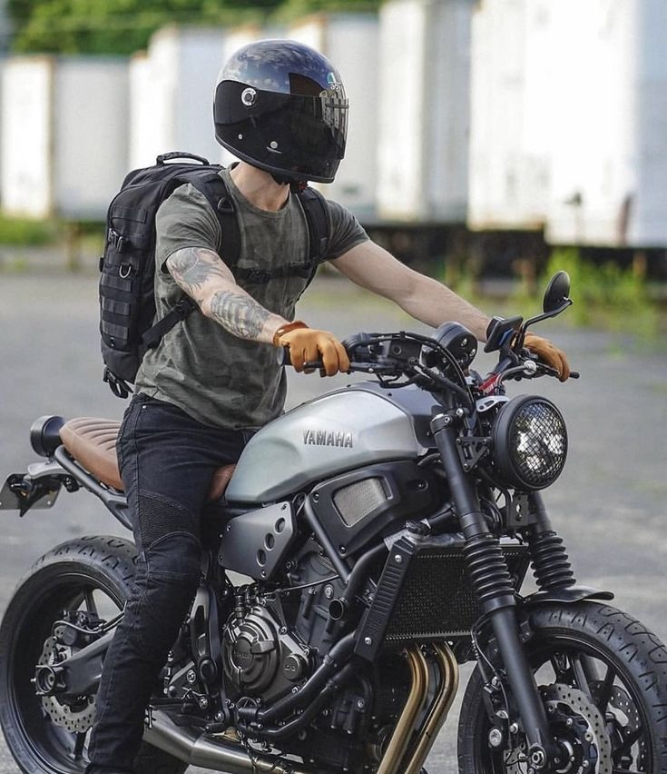 a man sitting on top of a motorcycle