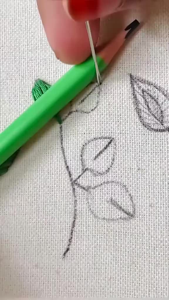 This may contain: someone is drawing on the fabric with a green marker