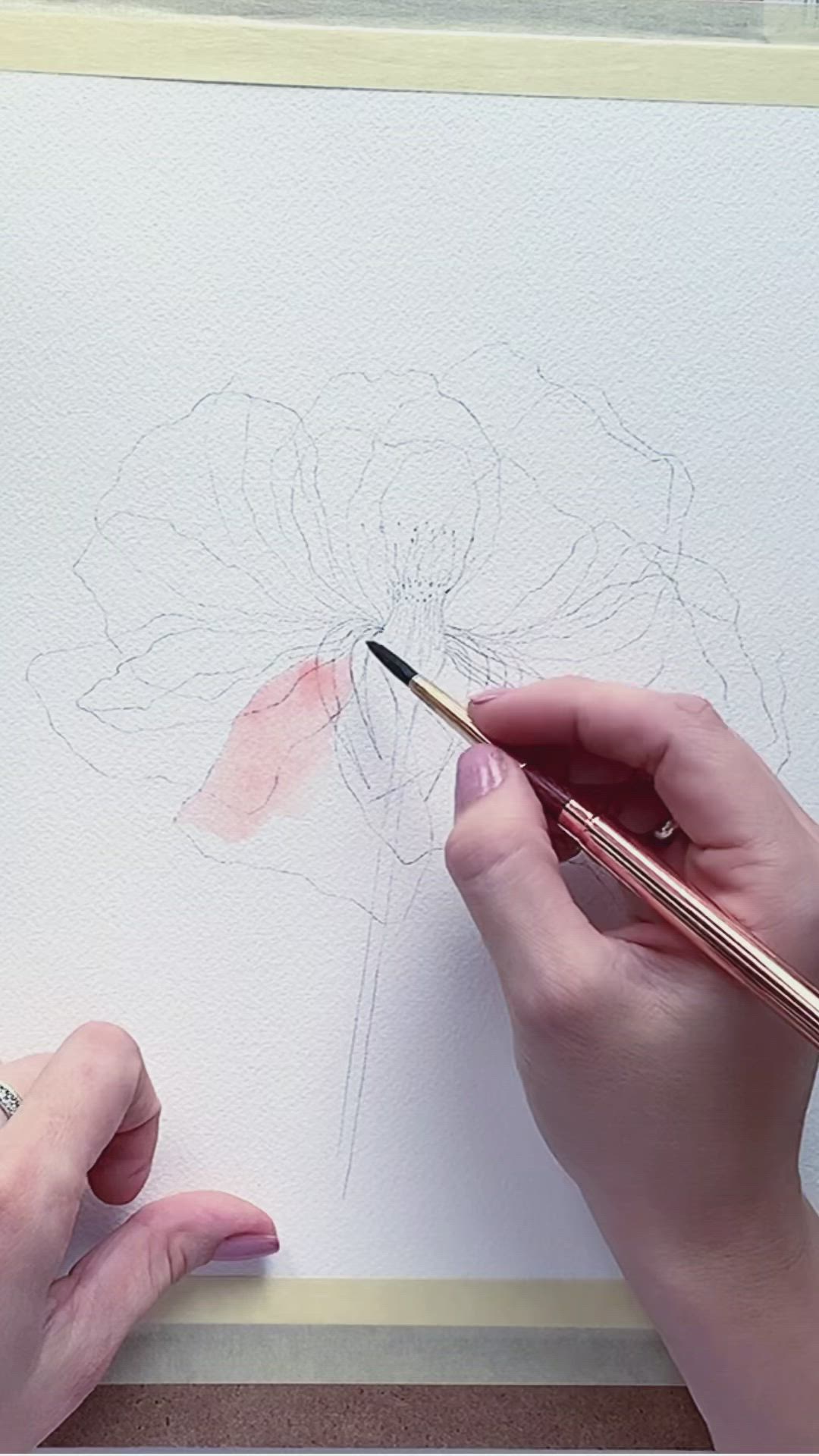 This may contain: a person is drawing a flower with watercolor pencils on the paper and holding a pen in their hand