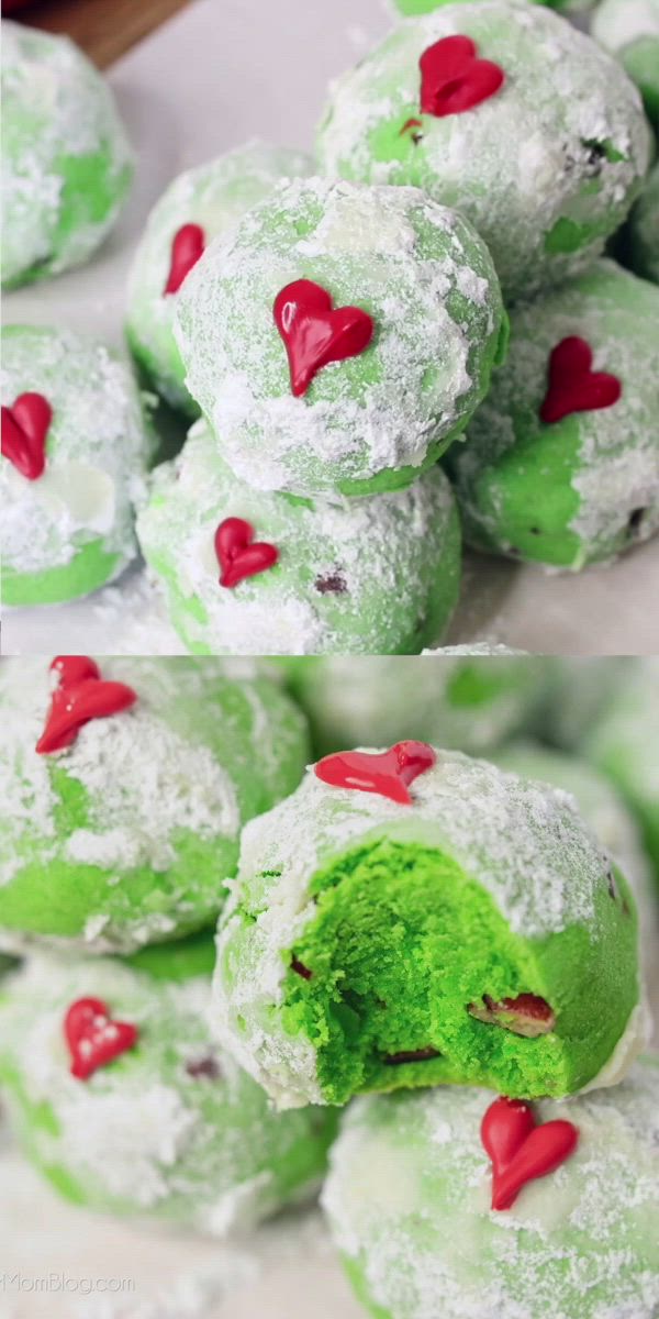 This may contain: green snowball cookies are stacked on top of each other with red hearts in the middle