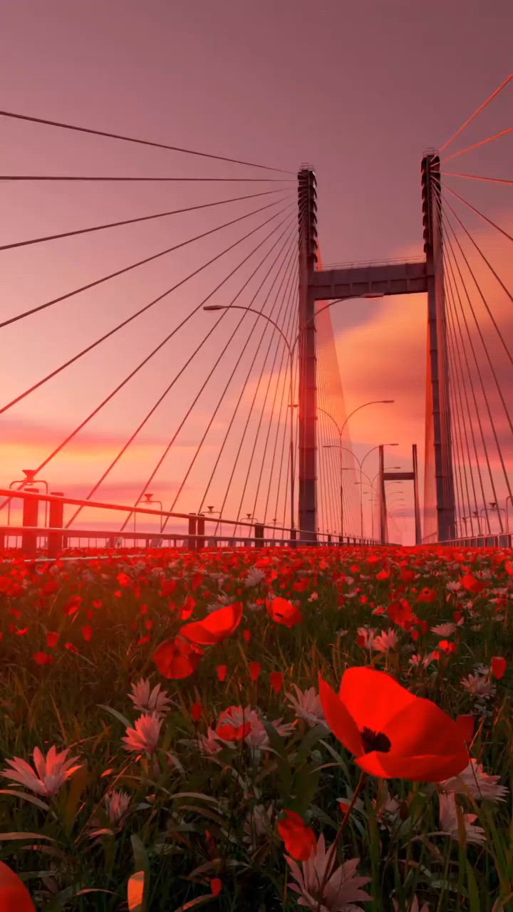 This may contain: the sun is setting over a bridge with red flowers in front of it and an orange sky
