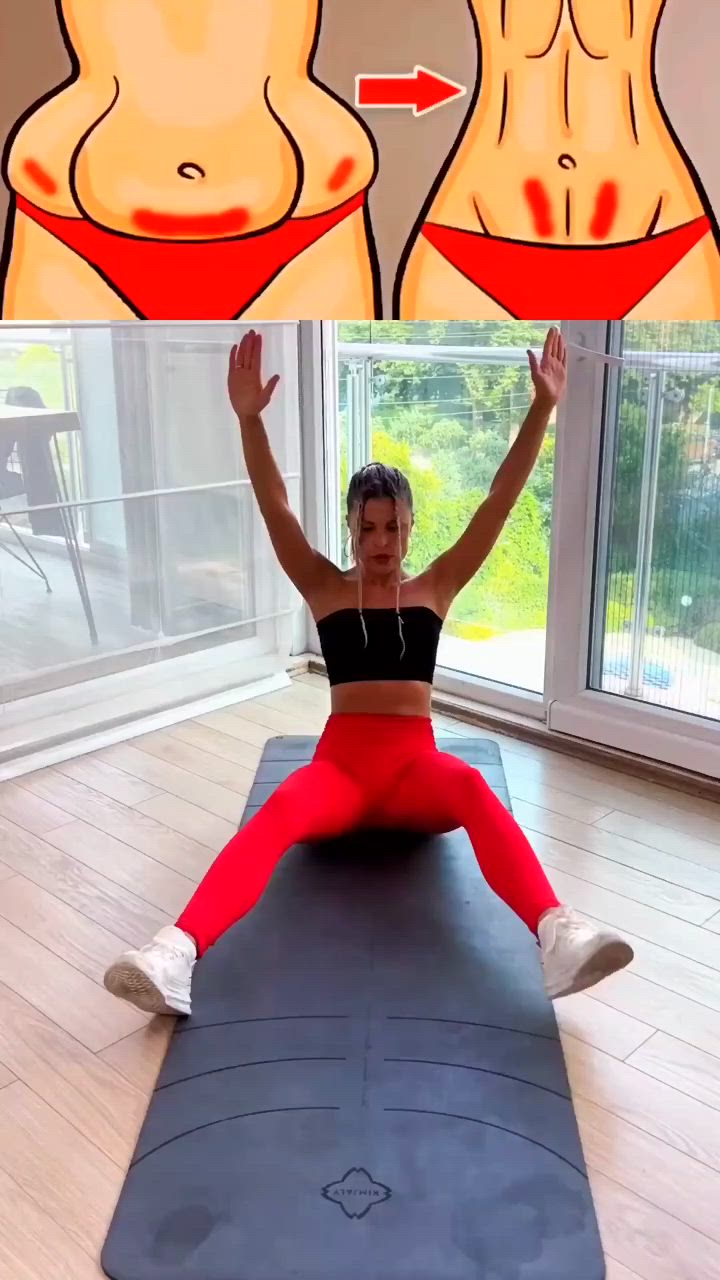 This may contain: a woman in red pants and black top doing exercises on a yoga mat with her hands up