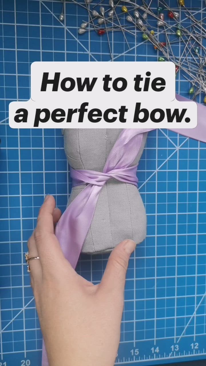 This may contain: someone is holding a stuffed animal with a ribbon on it's head and the words how to tie a perfect bow