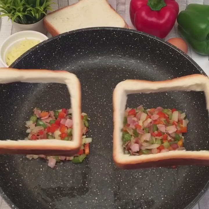 This may contain: two pieces of bread with toppings on them sitting in a frying pan next to some vegetables