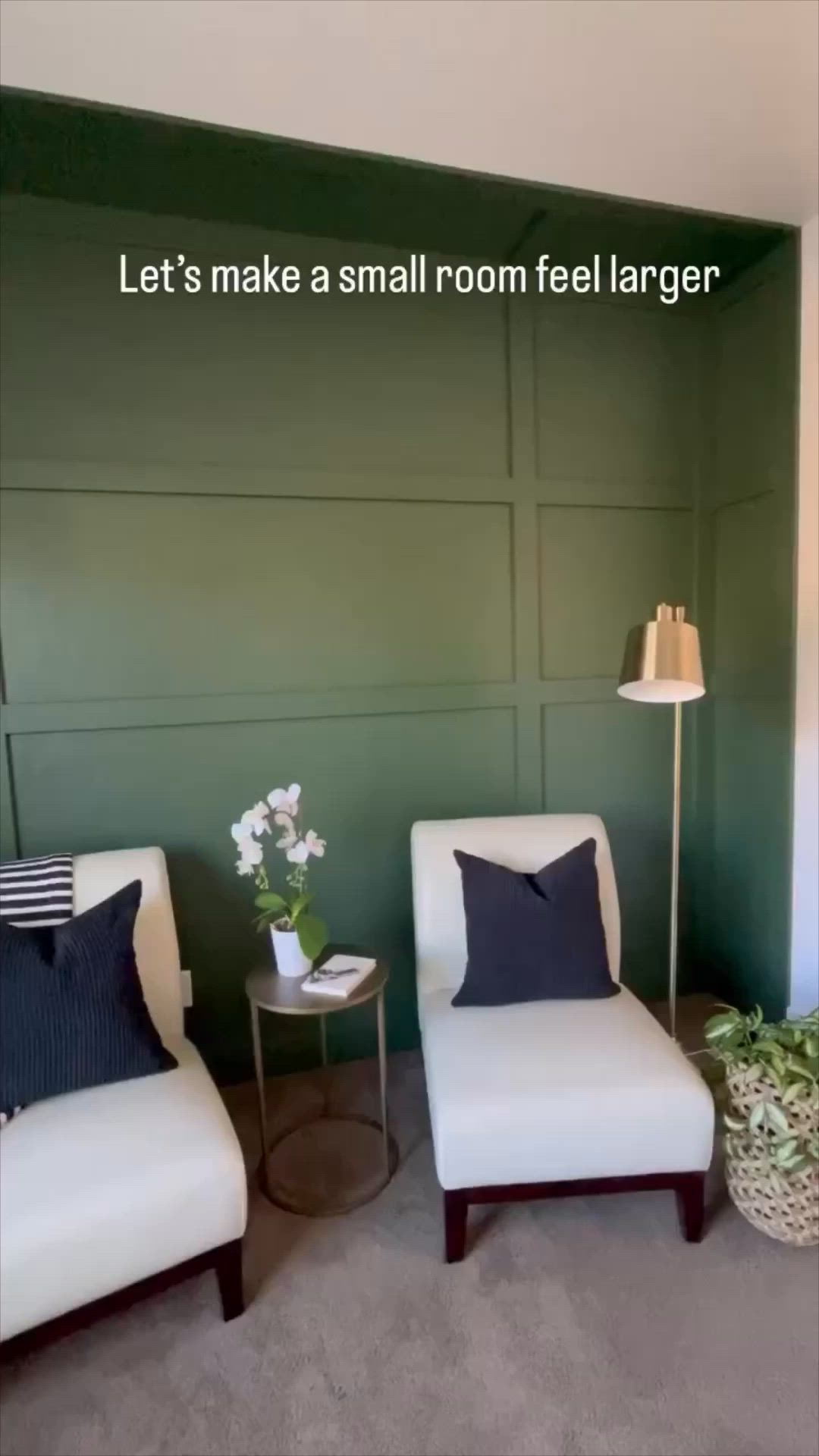 This may contain: two white chairs sitting next to each other in front of a green paneled wall