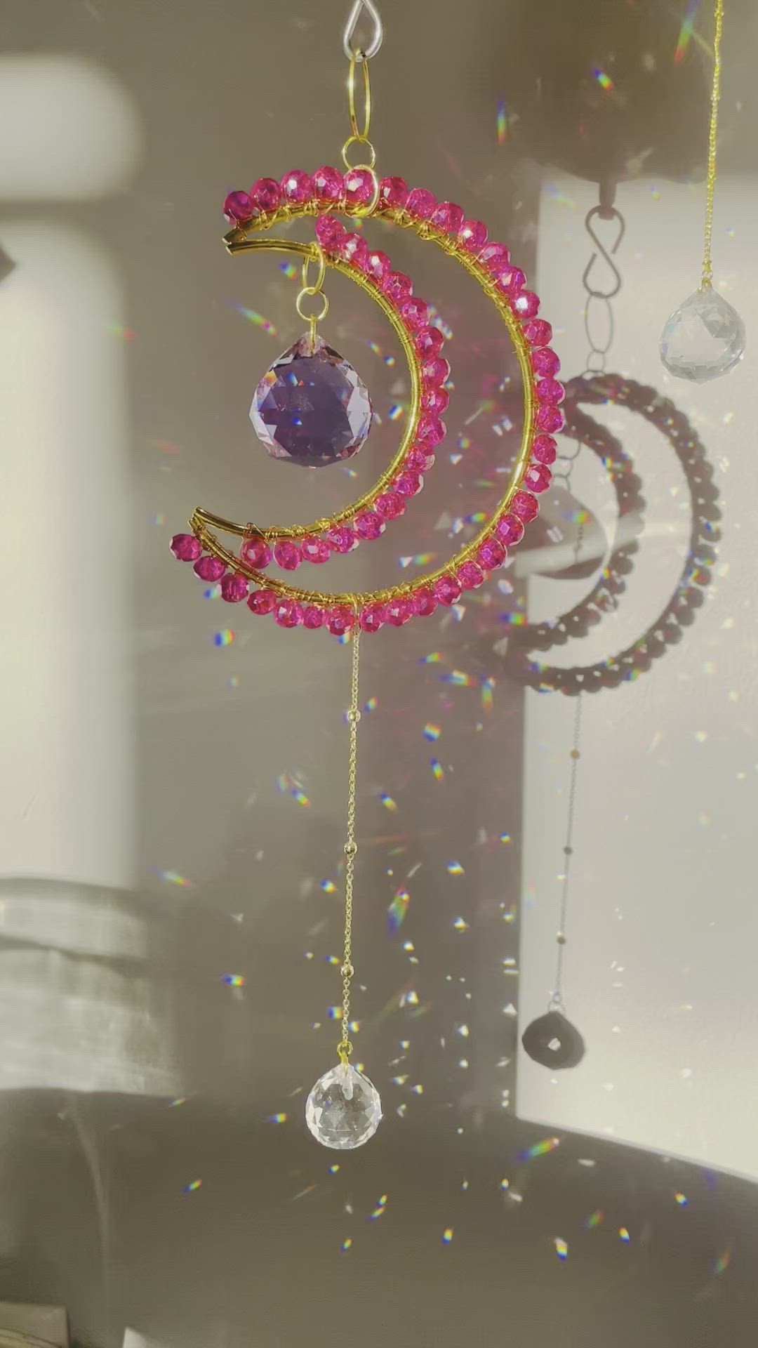 This may contain: a wind chime hanging from the ceiling in front of a window filled with beads