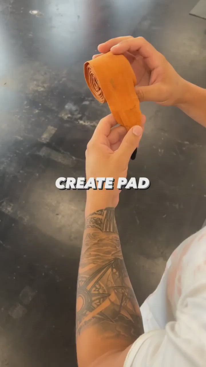 This may contain: a man holding an orange object in his hand with the words create pad on it