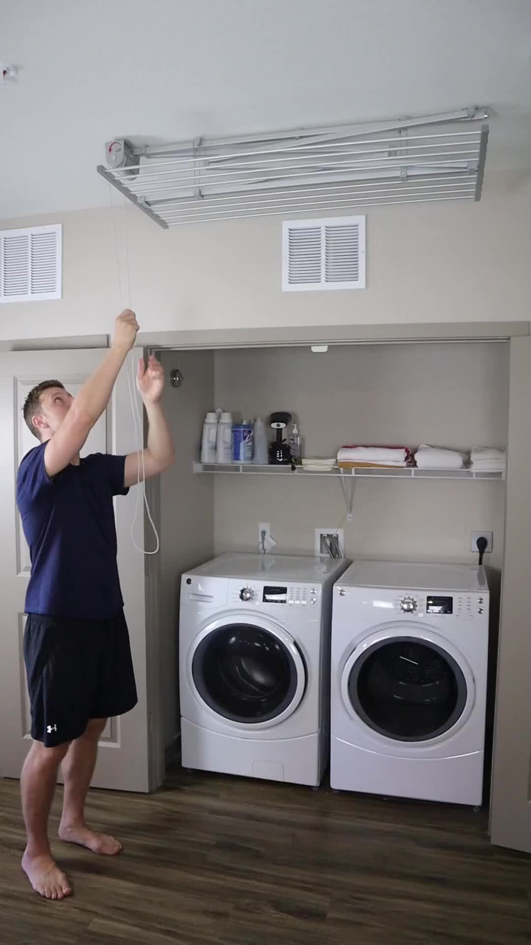 This may contain: a man standing in front of a washer and dryer