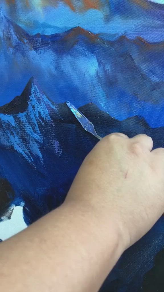 This may contain: a person is using scissors to paint a painting on a piece of paper with blue and black colors