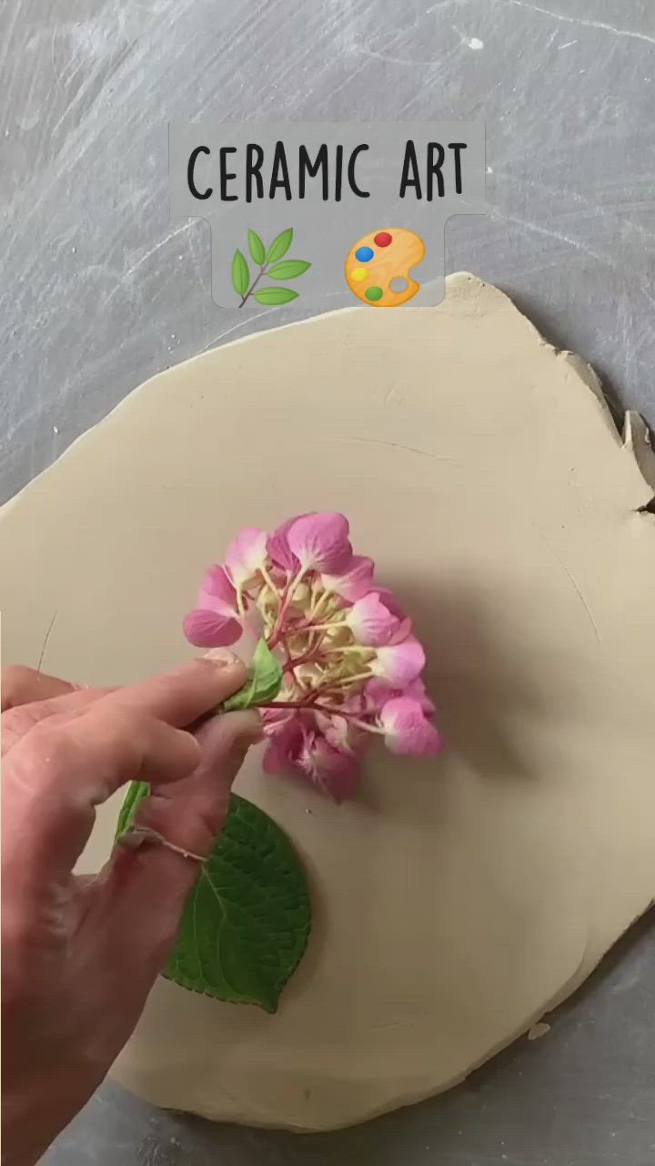 This may contain: someone is making a flower out of clay
