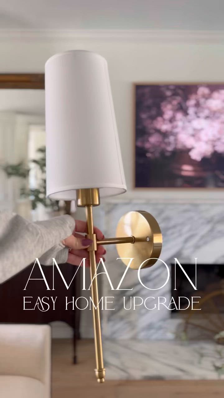 This may contain: a person holding a lamp in their hand with the caption amazon easy home upgrade