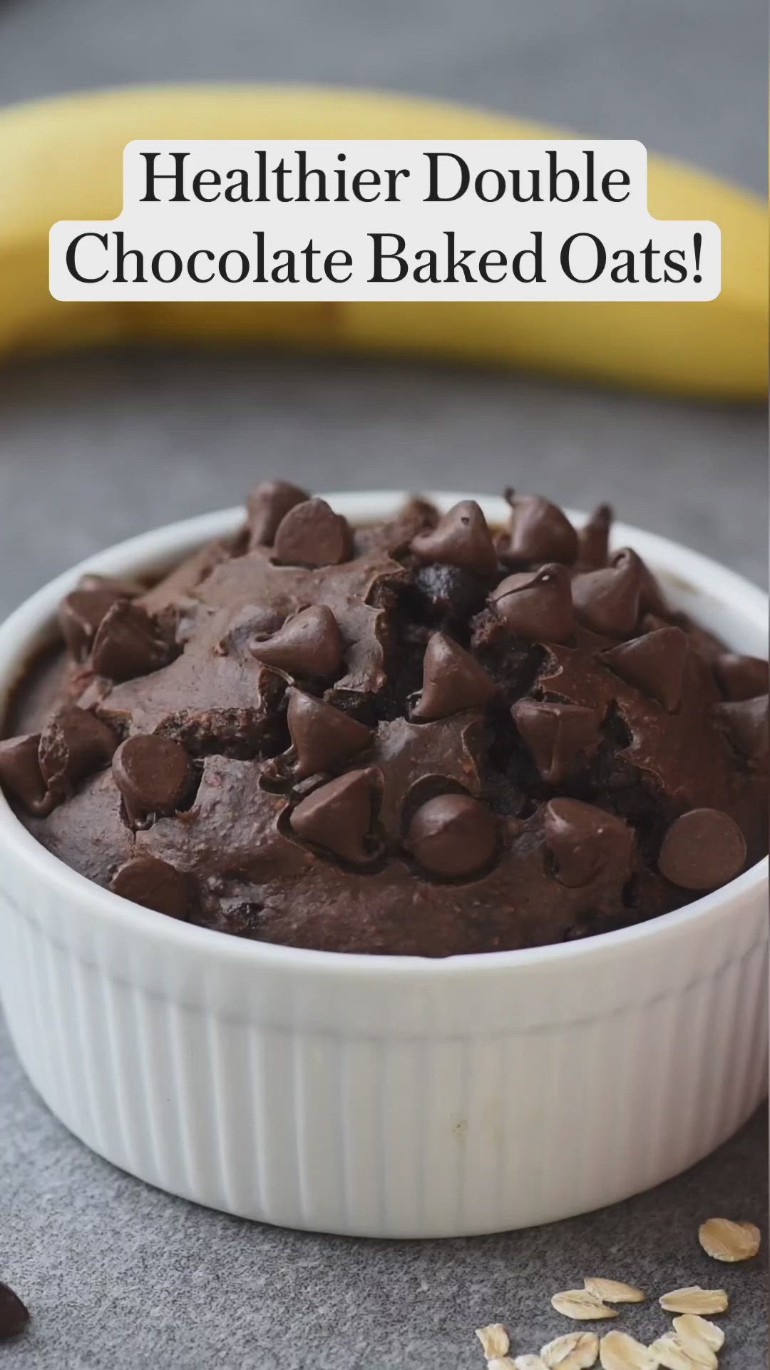 This may contain: a person holding a spoon over a bowl of chocolate baked oats with the words healthier double chocolate baked oats