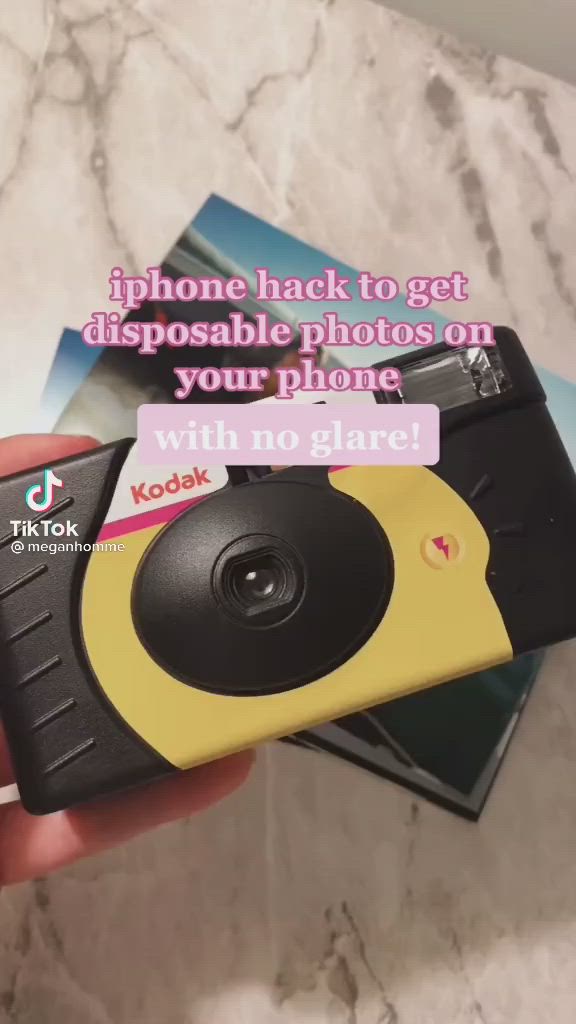 This may contain: someone holding up a camera with the caption phone hack to get disposable photos on your phone