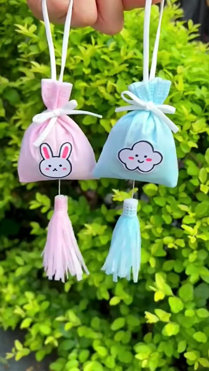 This may contain: three small bags with bunny ears hanging from them