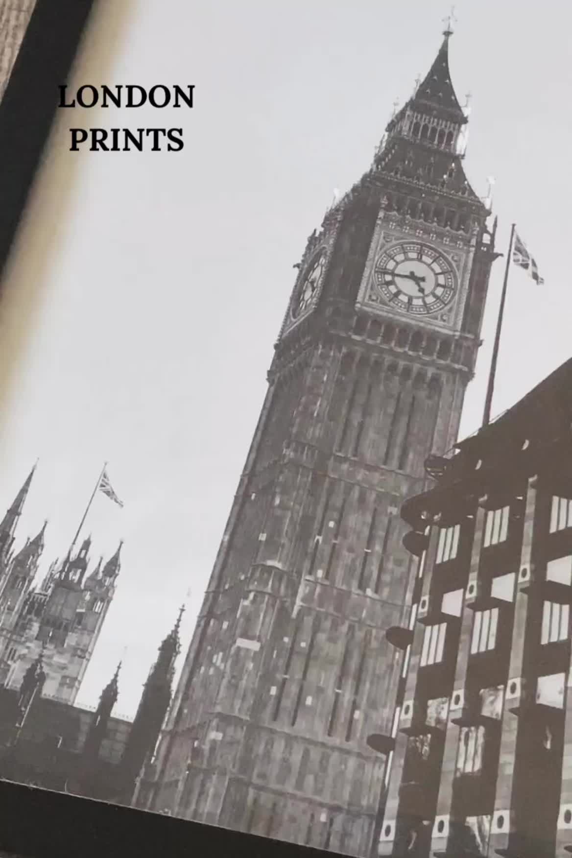 This may contain: the big ben clock tower towering over the city of london in black and white photograph