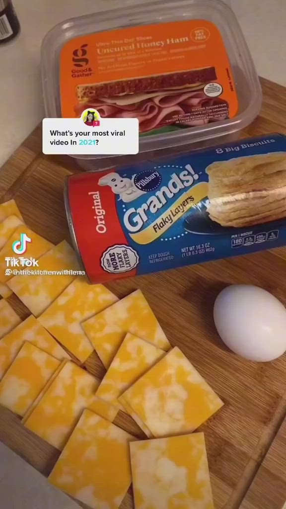 This may contain: some food is laying out on a cutting board next to an egg, butter and crackers