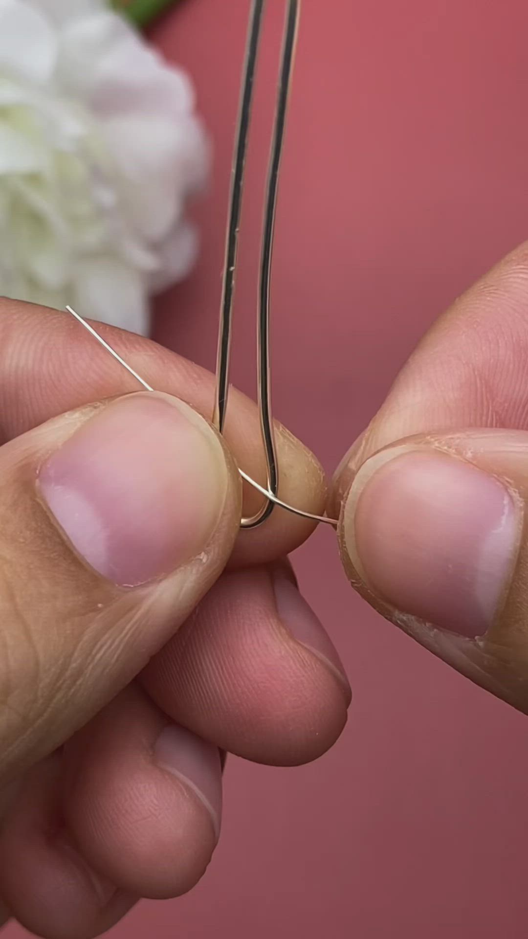 This may contain: a close up of a pair of scissors with a flower in the background and a wire wrapped around it