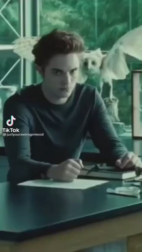 This may contain: a man sitting at a desk with a laptop computer in front of him and the words, my favorite twilight goes part 1