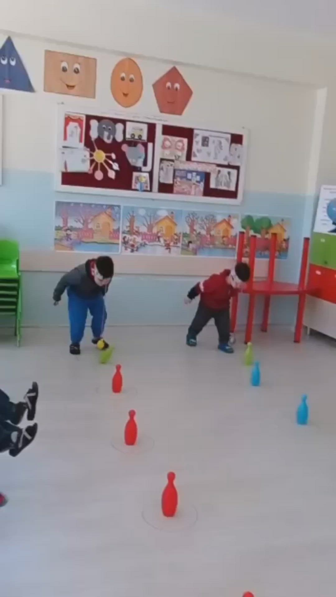 This may contain: two young boys playing with plastic cones in a room filled with children's toys