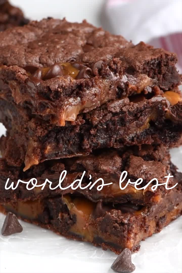 This may contain: someone is holding some brownies in their hand and the words world's best are above them