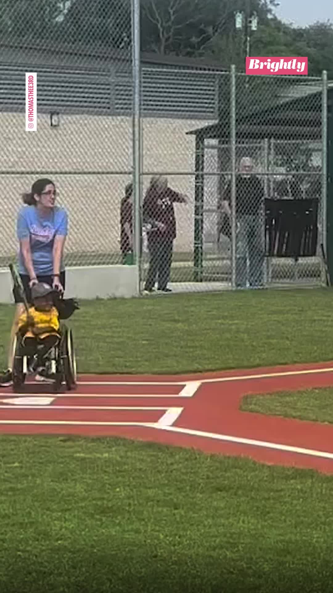 This may contain: a person in a wheel chair on a baseball field