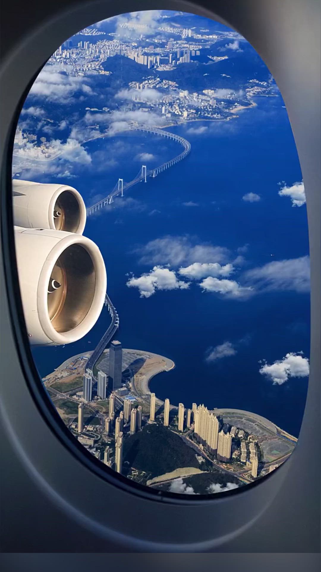 This may contain: an airplane window looking out at the city below