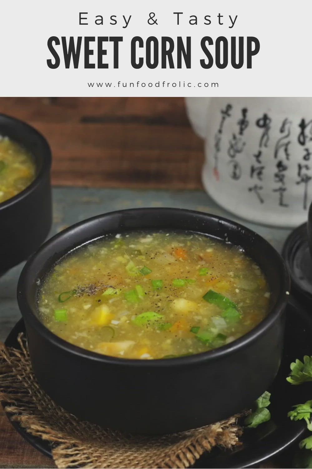 This may contain: two black bowls filled with soup on top of a wooden table