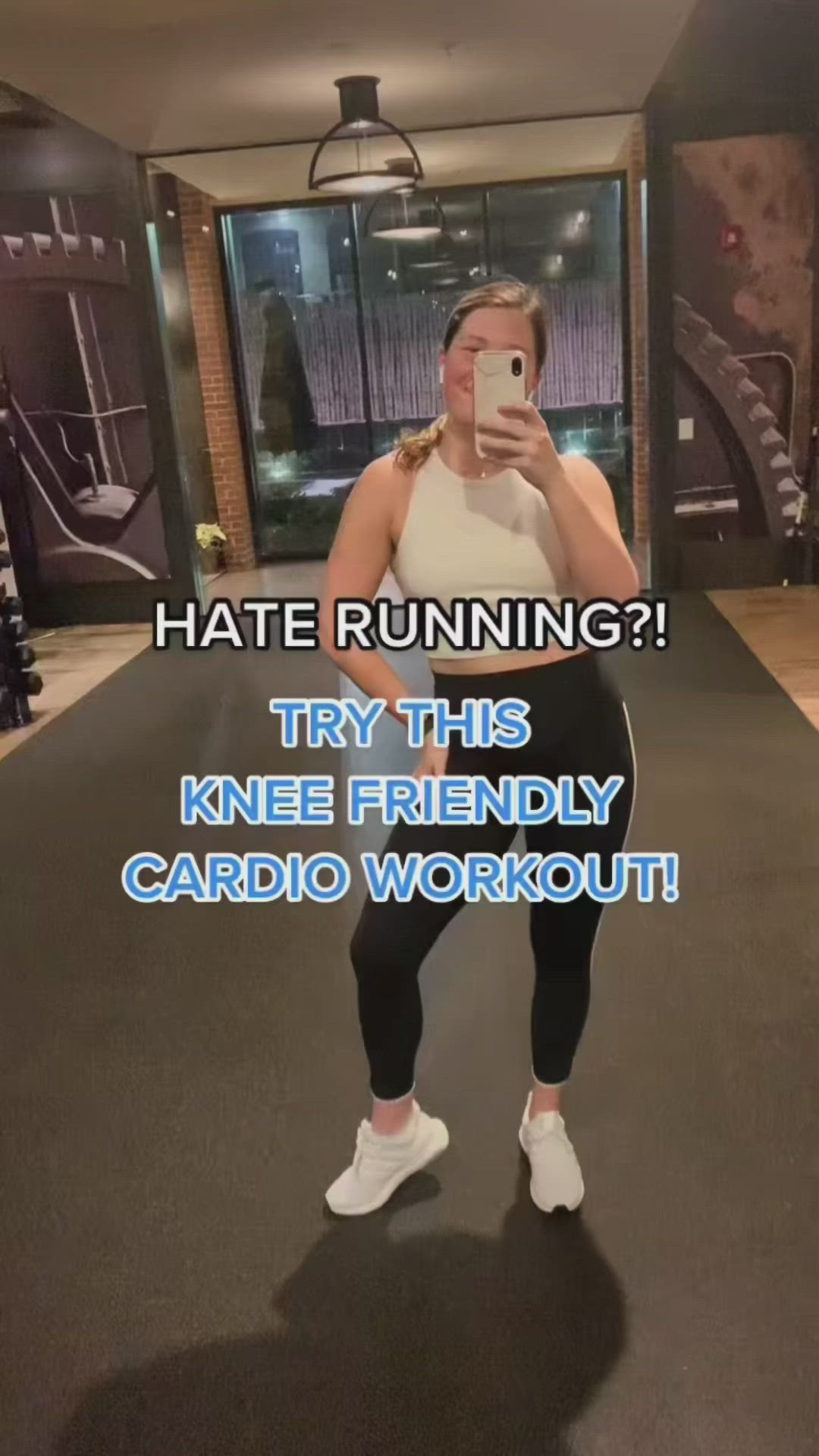 This may contain: a woman taking a selfie in the gym with her cell phone and text that reads, hate running? try this knee friendly cardio workout