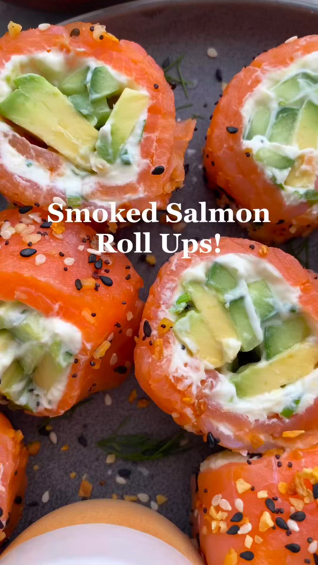 This may contain: smoked salmon roll ups with avocado on top