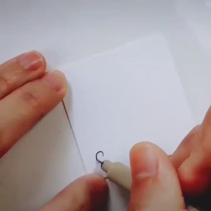 This may contain: someone is drawing something on paper with a pen