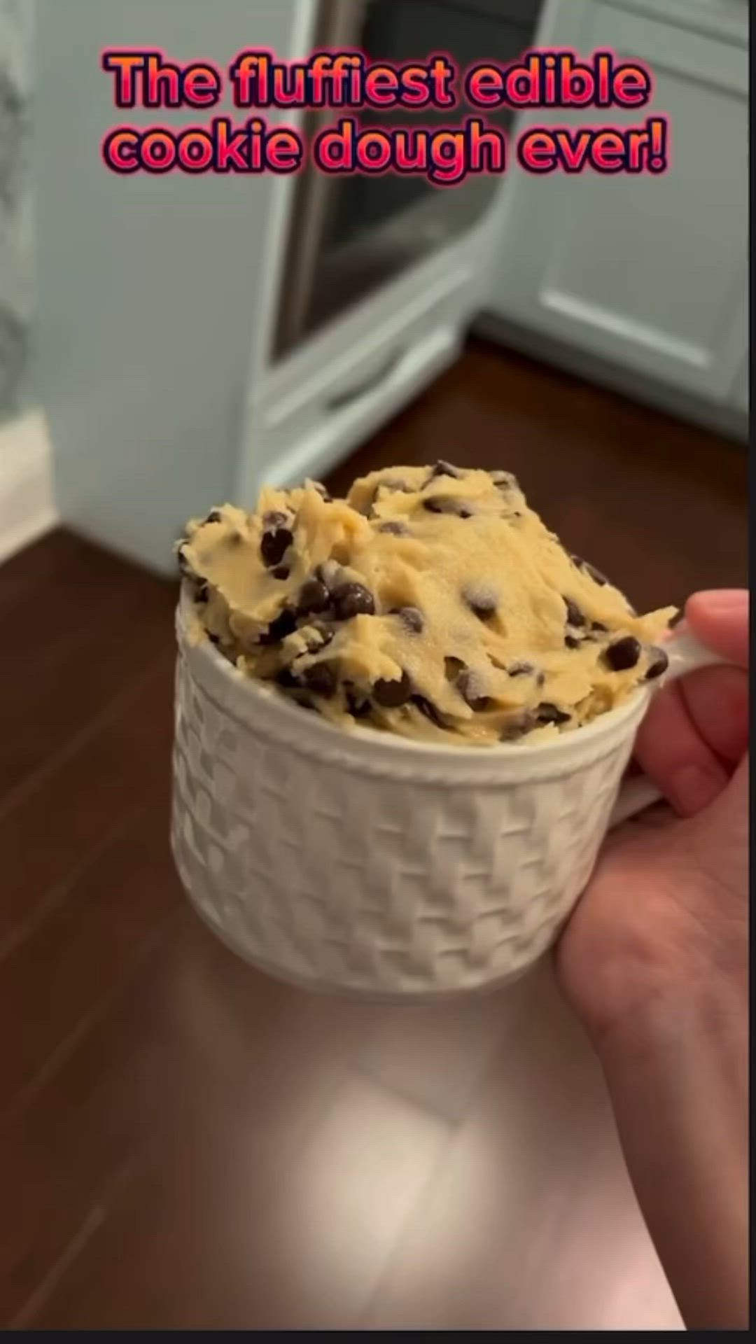 This may contain: someone is holding up a cookie dough in a cup that says, the flufflest edible cookie dough ever