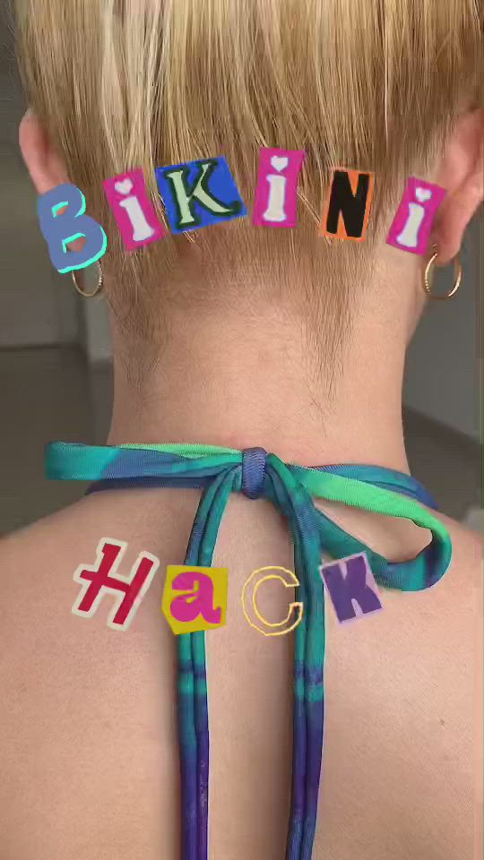 This may contain: the back of a woman's neck with letters spelling her name behind her head