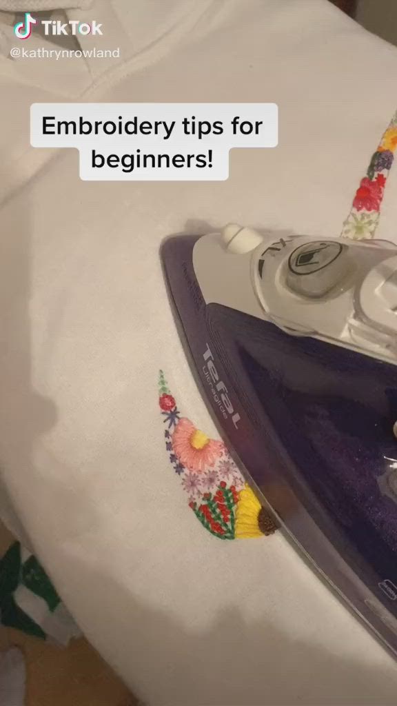 This may contain: an iron on top of a white sheet with the words embroidery tips for beginners