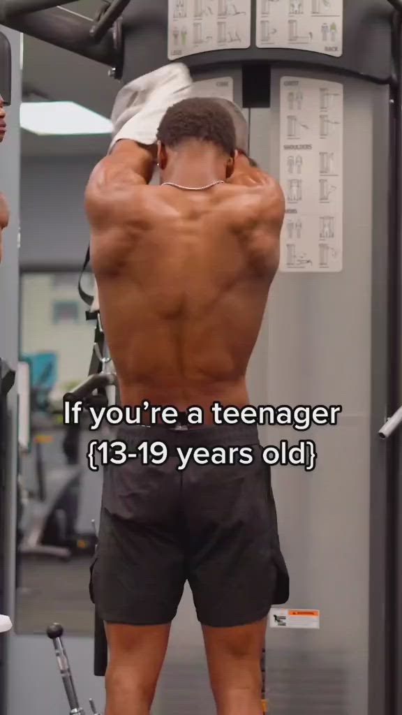 This may contain: a man standing in front of a gym machine with the words if you're a teenager, 13 - 19 years old