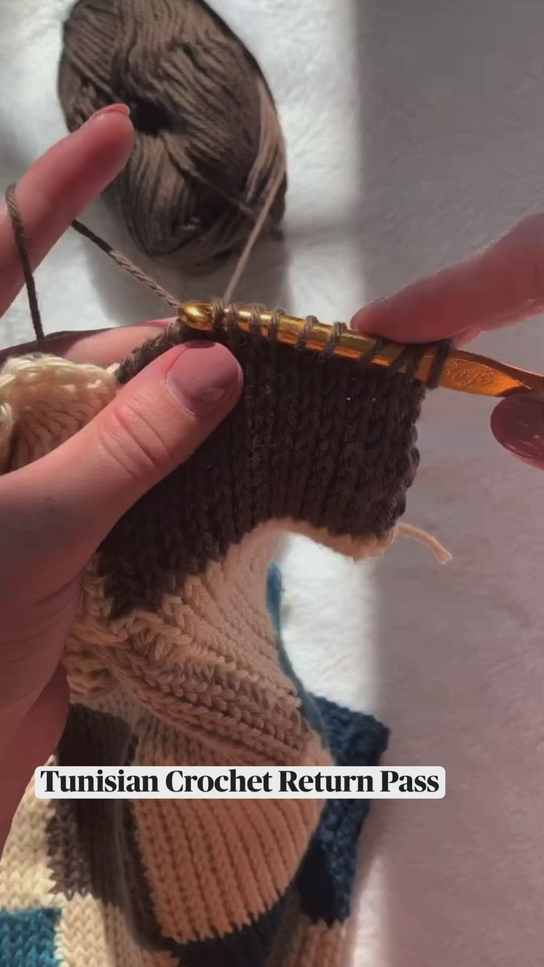 This may contain: someone is crocheting the ends of two yarns together to make a sweater