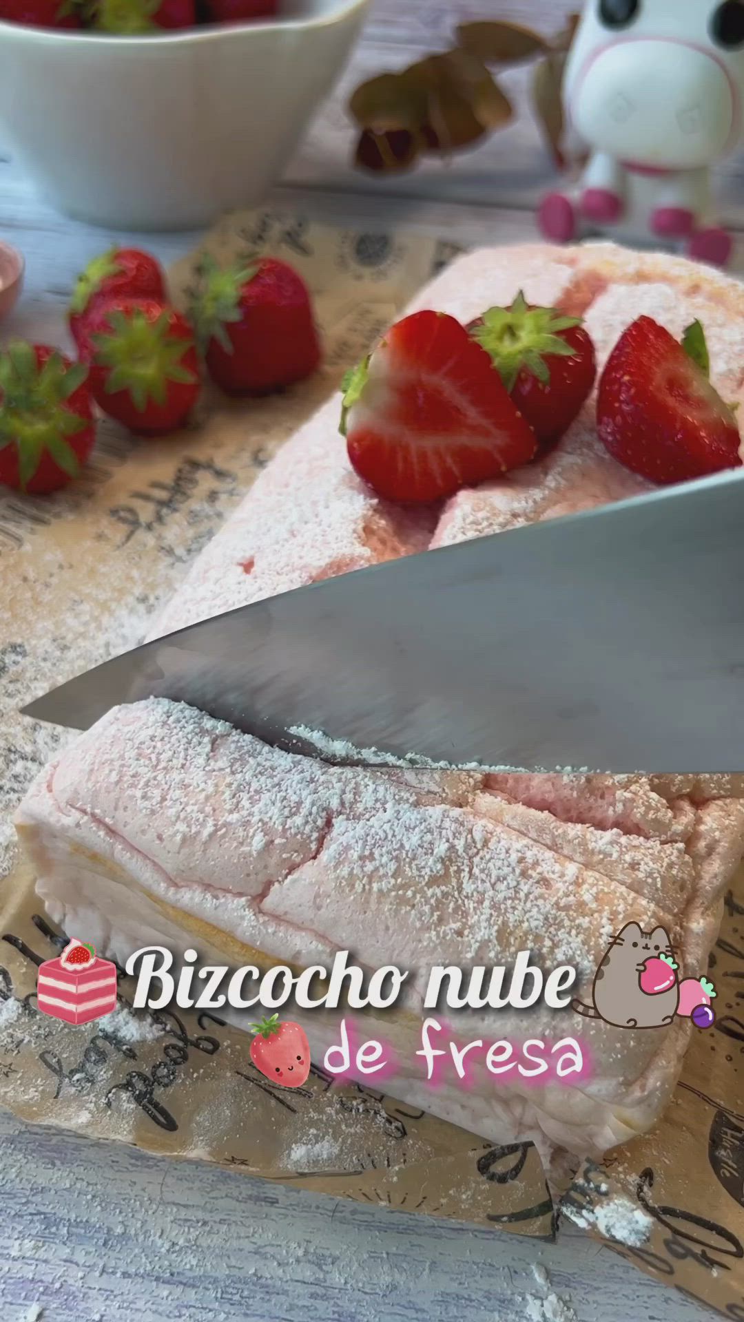This may contain: there is a cake with strawberries on it and a knife stuck in the frosting