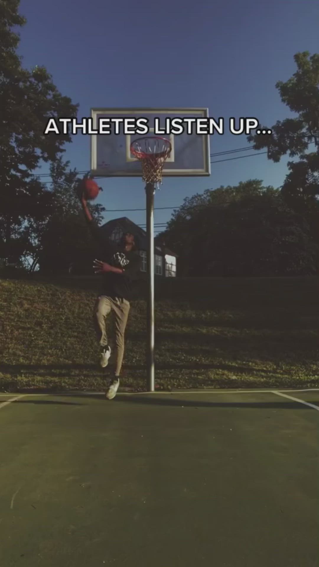 This may contain: a man jumping up into the air to dunk a basketball in front of a sign that says athletes listen up