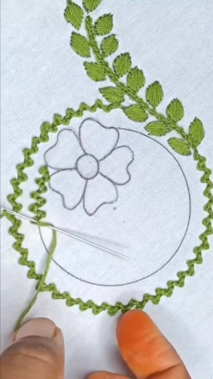 This may contain: someone is stitching a flower on a piece of paper