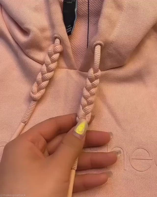 This may contain: someone is doing something that looks like a rope with yellow and white nail polishes